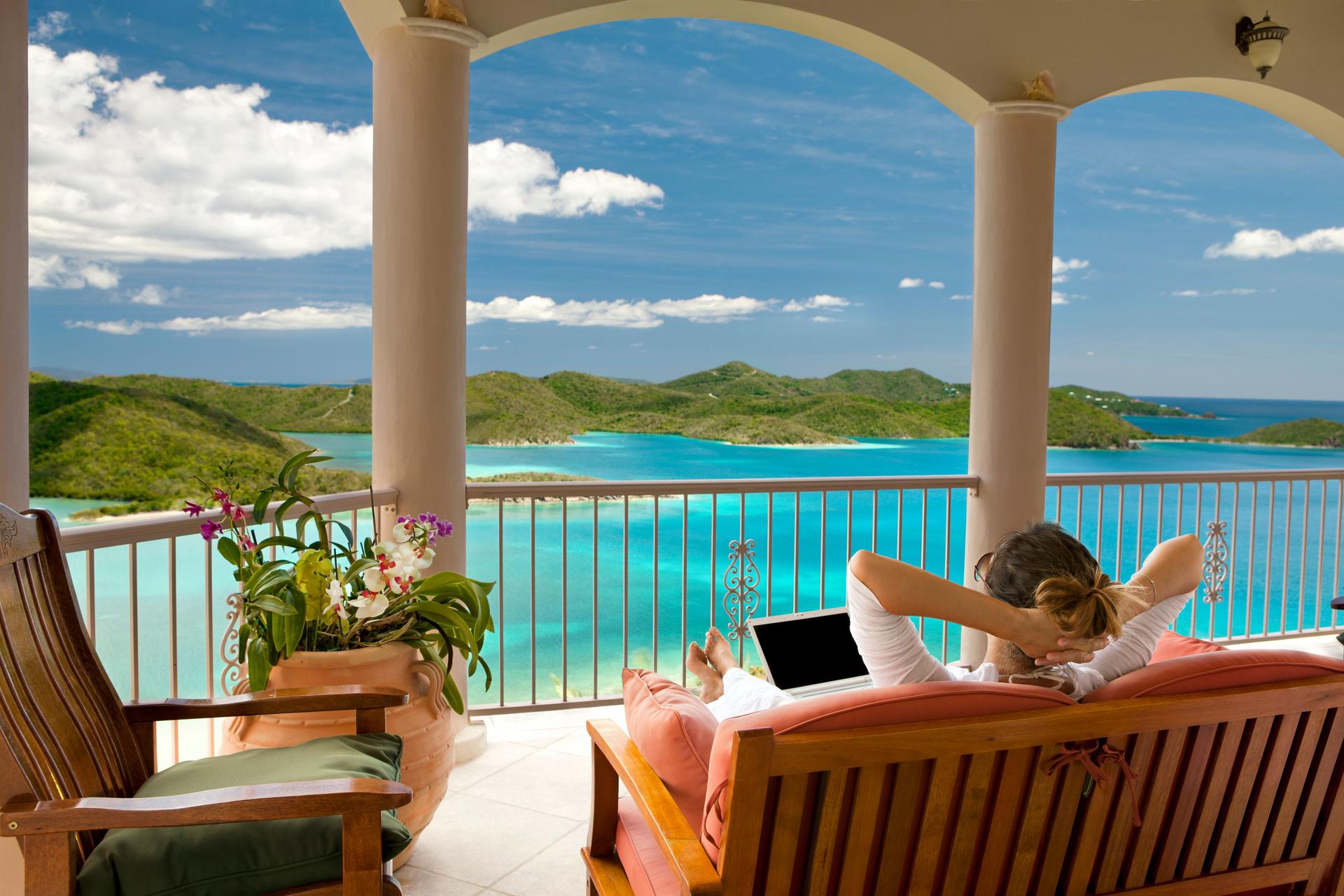 businesswoman with laptop relaxing on her vacation in the Caribbean